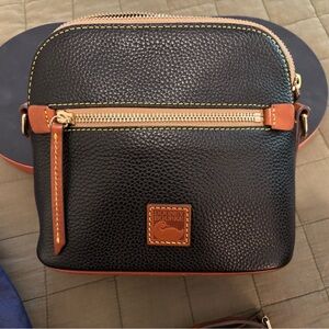 Dooney & Bourke Domed Black Pebble Leather Crossbody Bag with Tan Trim.